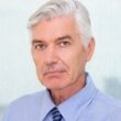 Confident senior businessman with digital tablet